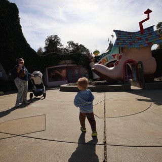 Child Exploring Whimsical Toontown at Theme Park