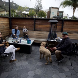 Family Gathering Around Patio Fire Pit at Dusk