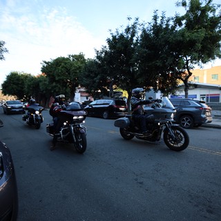 Motorcyclists Cruising Through Evening Urban Street
