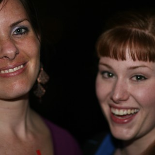 Two Friends Laughing Together at a Nighttime Event