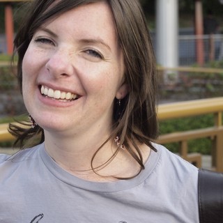 Joyful Woman Laughing Outdoors at Urban Park