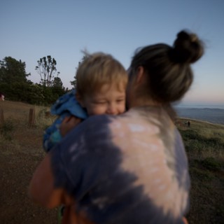 Mother and Child Embrace at Twilight Hilltop