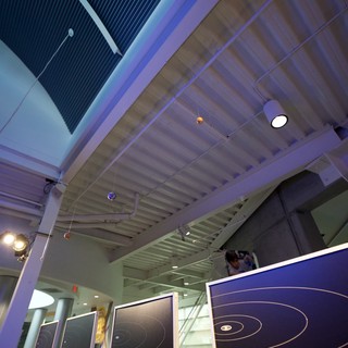 Modern Science Museum Interior with Orbital Display Panels