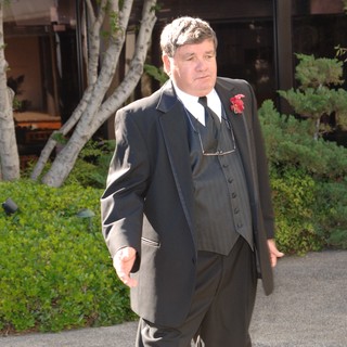 Dapper Gentleman in Three-Piece Suit at Wedding
