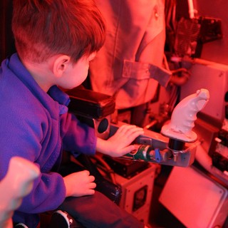 Young Student Exploring Science Under Red Light