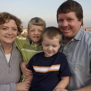 Family Portrait at Sunset Over City Skyline