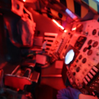 Red-Lit Space Station Interior Display at Science Center