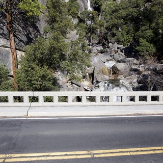 Mountain Highway with Cascading Waterfall Vista