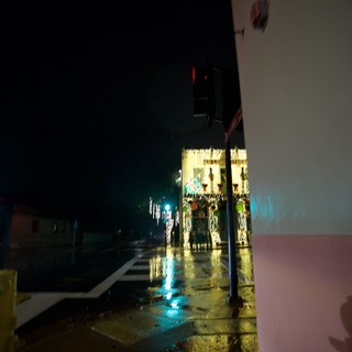 Wet Night Street with Festive Lights and Blue Glow