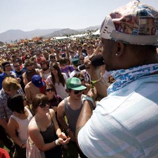 Man in Hat and Bandana Leads Coachella Crowd
