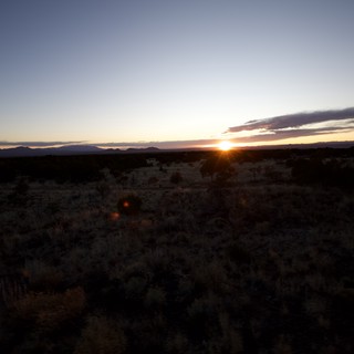 Desert Sunset Over Distant Mountain Range
