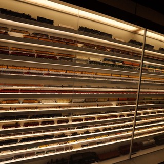 Extensive Model Train Collection Display with Illuminated Shelving