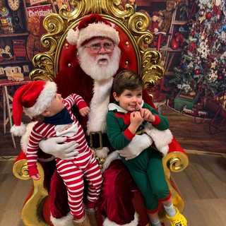 Two Children Visit Santa in His Workshop Grotto