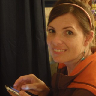 Woman Smiling with Phone at Wedding Reception