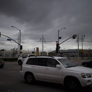 SUV on a Cloudy Urban Road Intersection