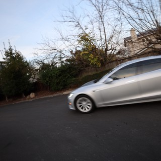 Silver Sedan in Motion at Dusk