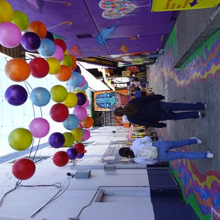 Colorful Balloon Installation in Vibrant Street Alley