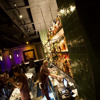 Upscale Bar Interior with Green Tile and Purple Ambiance