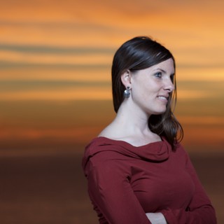 Woman Gazing Into a Fiery Sunset Sky