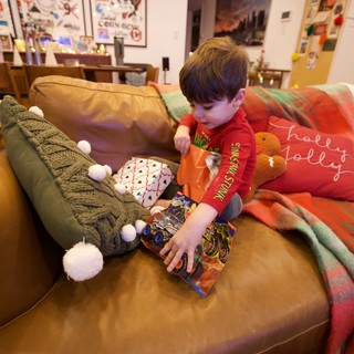 Christmas Morning Joy: Child Opening Holiday Gifts