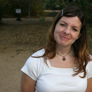 Young Woman Smiling Outdoors in Autumn Garden