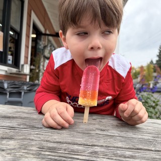 Pure Joy: Child Enjoying a Colorful Popsicle Outdoors