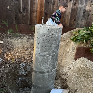 Concrete Pier Footing with Anchor Bolts in Backyard