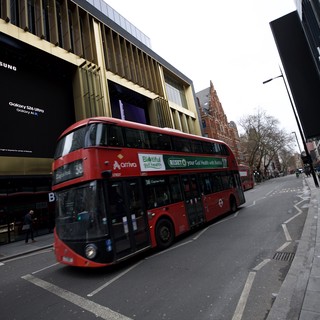 Red Double-Decker Bus on Modern London Street