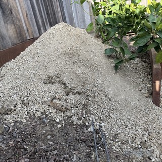 Fresh Gravel Pile in Residential Backyard Construction