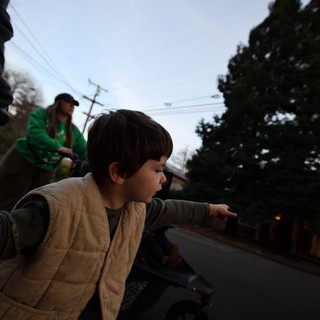 Child Points Forward on Evening Street Walk