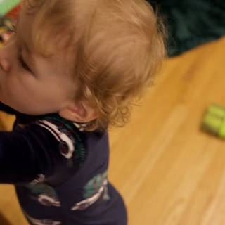 Young Child Playing on Wooden Floor at Home
