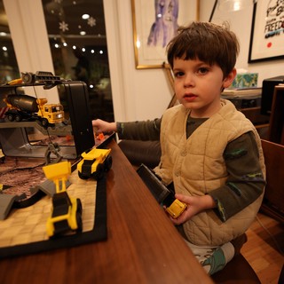Young Boy Playing with Construction Toy Set at Home