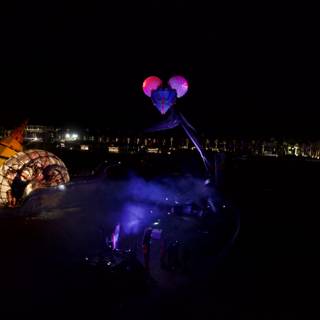 Illuminated Purple Balloon in the Urban Night Sky