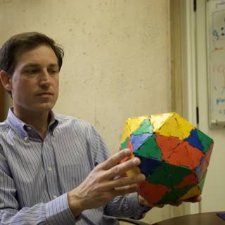 Colorful Sphere in the Hands of a Man