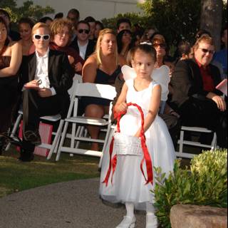 Little Girl in a White Dress at a Wedding