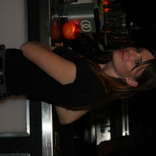 Woman at Bar Counter in Dim Nightclub Light