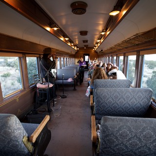 Vintage Train Car Entertainment Experience in Desert Landscape