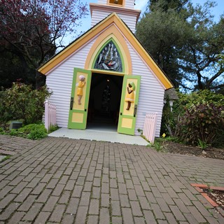 Whimsical Chapel Entrance with Colorful Doors and Steeple