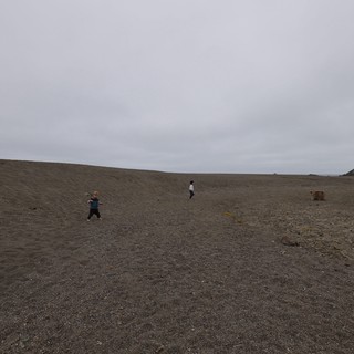 Children Playing on Vast Dark Sand Dunes
