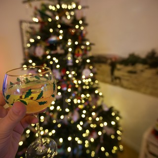 Christmas Toast with Festive Wine Glass and Tree