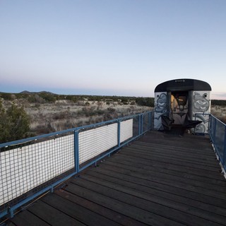 Abandoned Train Car on Desert Observation Deck at Twilight