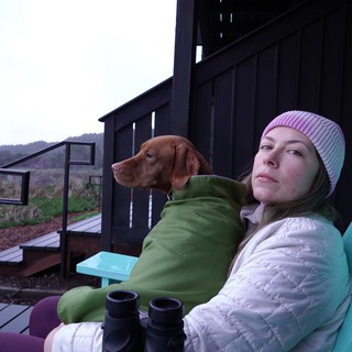 Woman and Dog Relaxing on Outdoor Deck