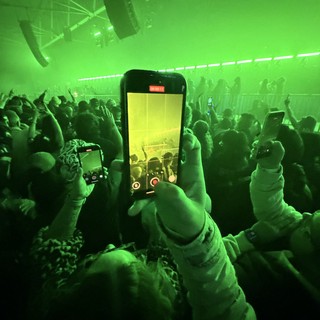 Recording a Concert Through Phone Screen in Green Light