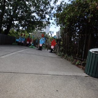 Colorful Character Cutouts Along Garden Pathway