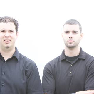 Smiling Brothers in Black Shirts