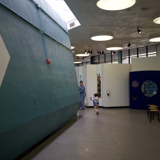Child Running Through Modern School Hallway with Skylights