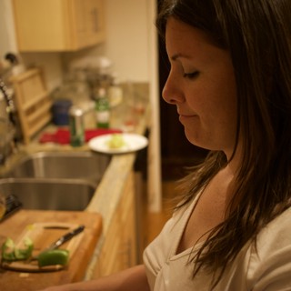 Woman Chopping Vegetables in a Cozy Kitchen