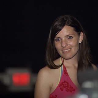 Smiling Woman at a Dimly Lit Evening Venue