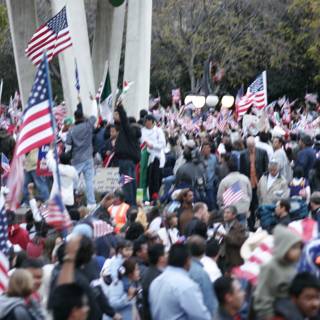 Patriotic crowd waves American flags