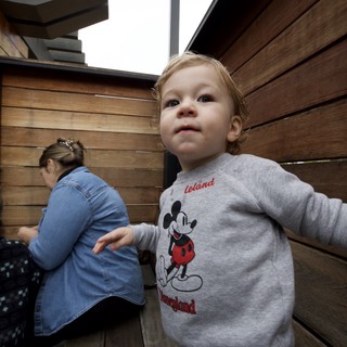 Toddler in Mickey Mouse Sweatshirt Exploring Indoor Space